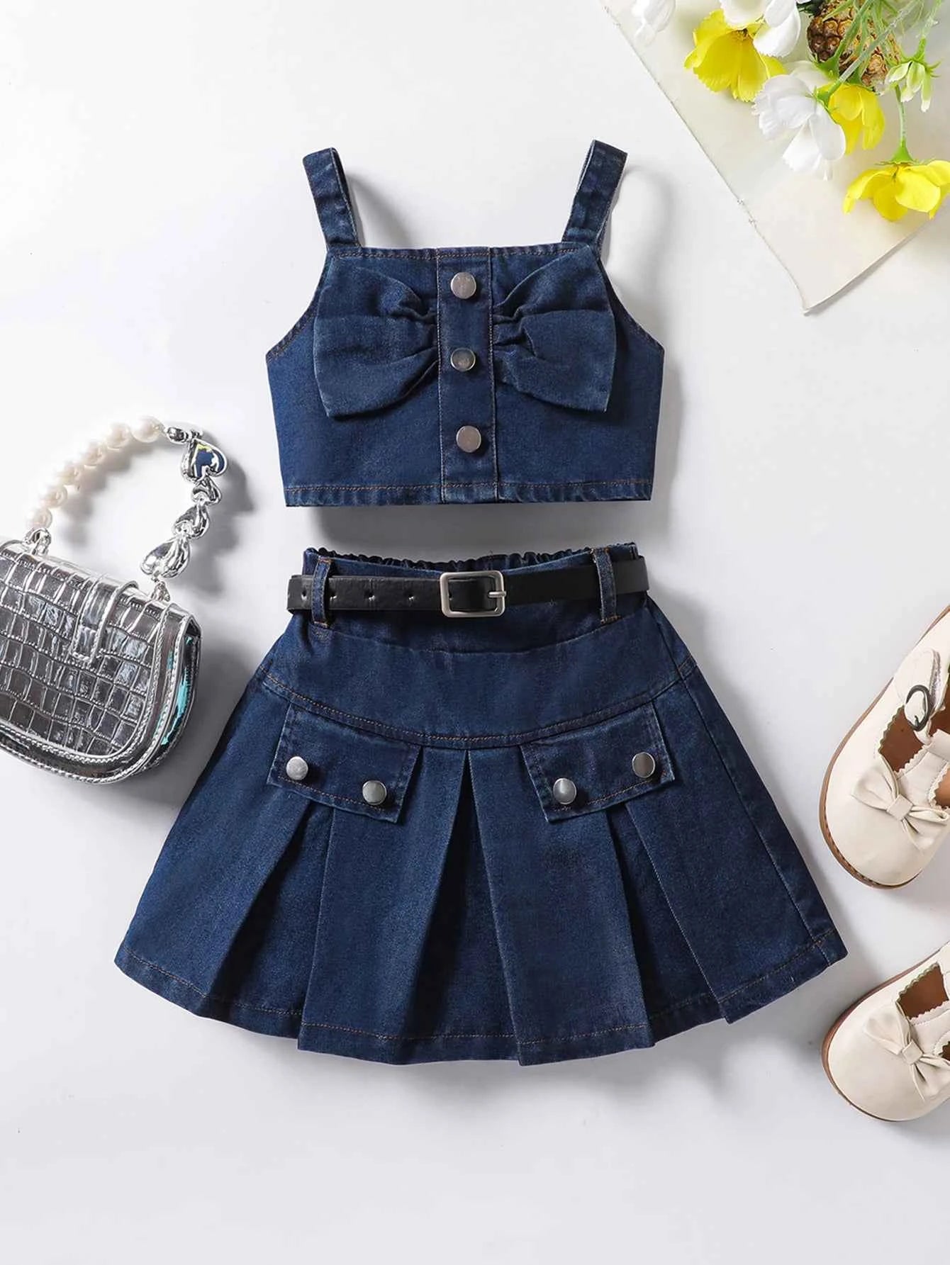 The girl-loved denim pleated skirt set features a bow blouse with an attached belt.