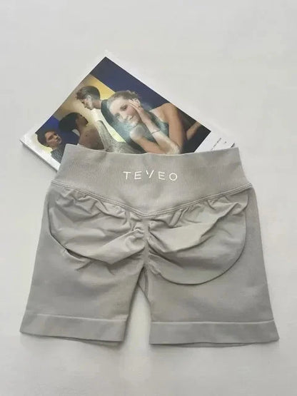 TEVEO Short De Yoga Femme Extensible Respirant Pêche Hanche Hanche Fitness Short de Course Hanche Haute Stretch Mèches De Sueur